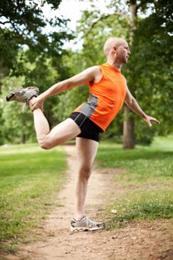 Middle Age man stretching before a jog Middle Age man stretching before a jog