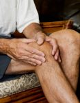 man massaging painful knee