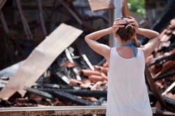 Destroyed House Woman in Crisis